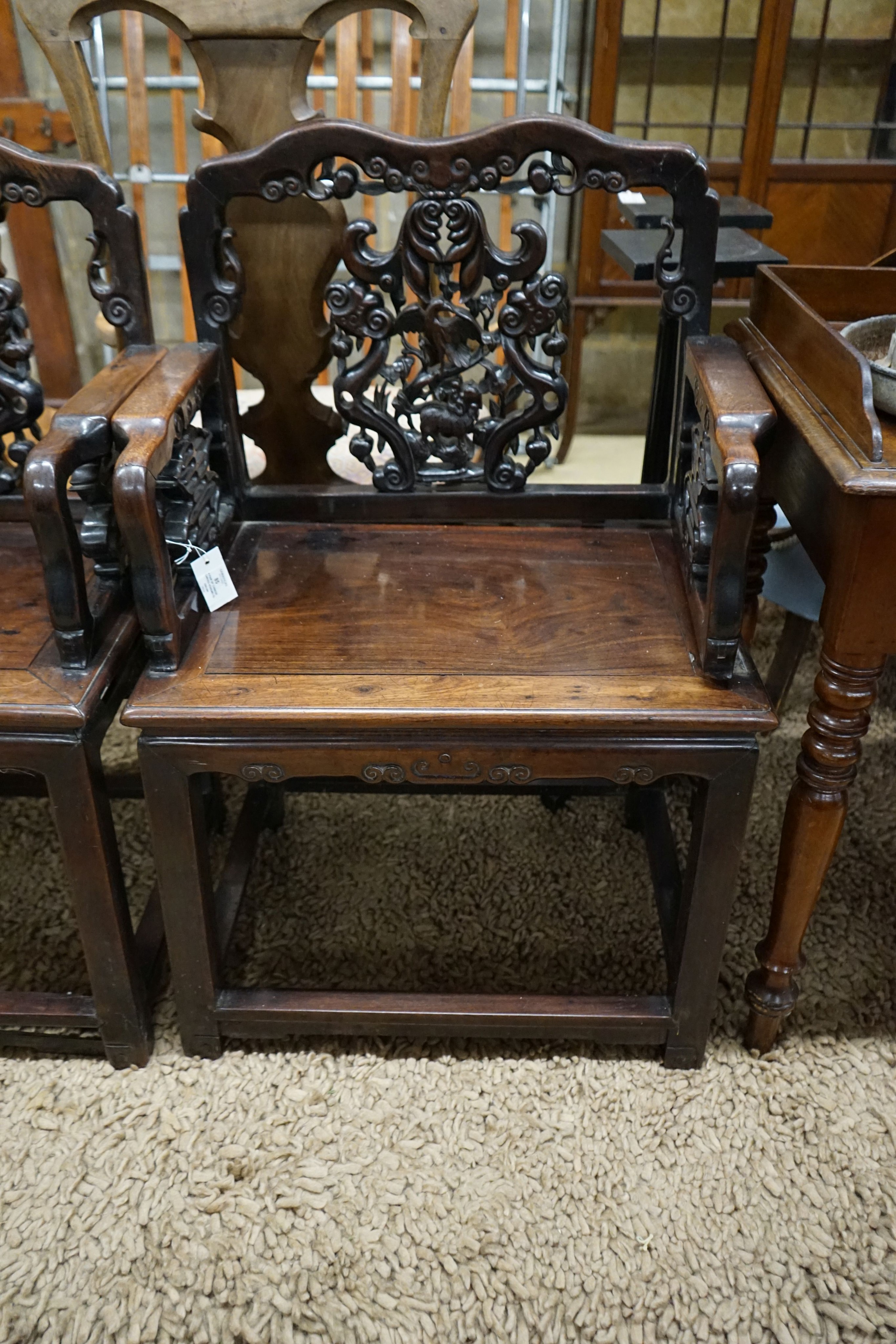 A pair of Chinese carved hongmu elbow chairs (a.f.), width 65cm, depth 48cm, height 96cm